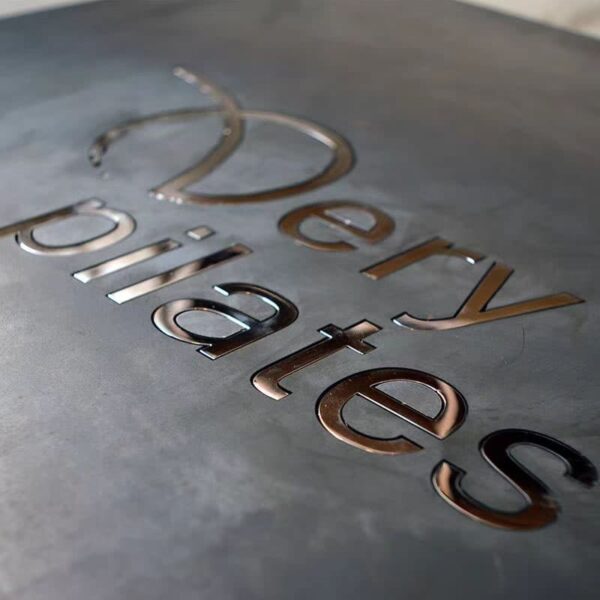 Close-up of a personalized metal sign with polished 3D stainless steel letters