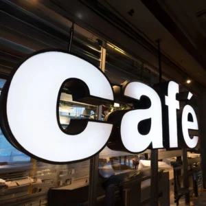 custom-3d-illuminated-letter-sign. cafe with bright white LED lighting, mounted on a glass storefront.