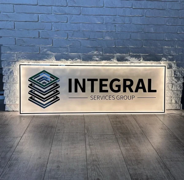 Custom acrylic sign featuring the "Integral Services Group" logo with a modern and professional design, highlighted by soft backlighting.