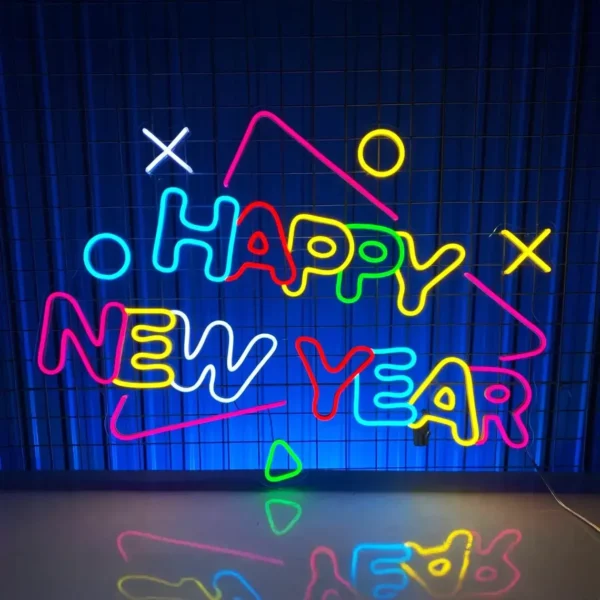 Vibrant neon sign with "Happy New Year" text in colorful designs, highlighted by playful geometric shapes and patterns, perfect for celebrations.