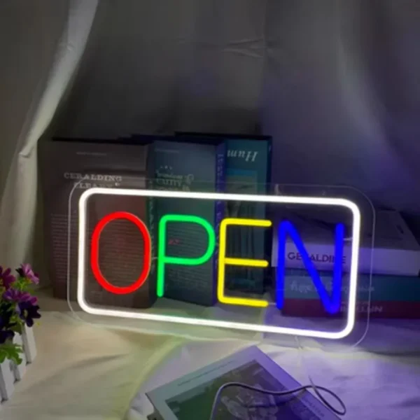 Bright and colorful neon "OPEN" sign featuring red, green, yellow, and blue letters outlined with a glowing white border, perfect for storefronts and businesses.