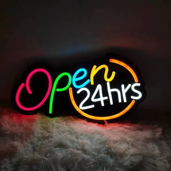 Bright neon "Open 24hrs" sign glowing vibrantly, placed against a cozy background.