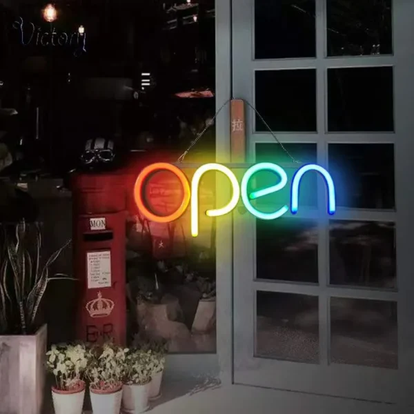 Bright and colorful neon "OPEN" sign illuminating a shop's entrance in vibrant rainbow hues, creating a warm and inviting ambiance.