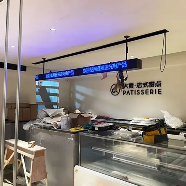 P2 HD Full Color LED Sign displaying Chinese text above a patisserie counter in a modern setup