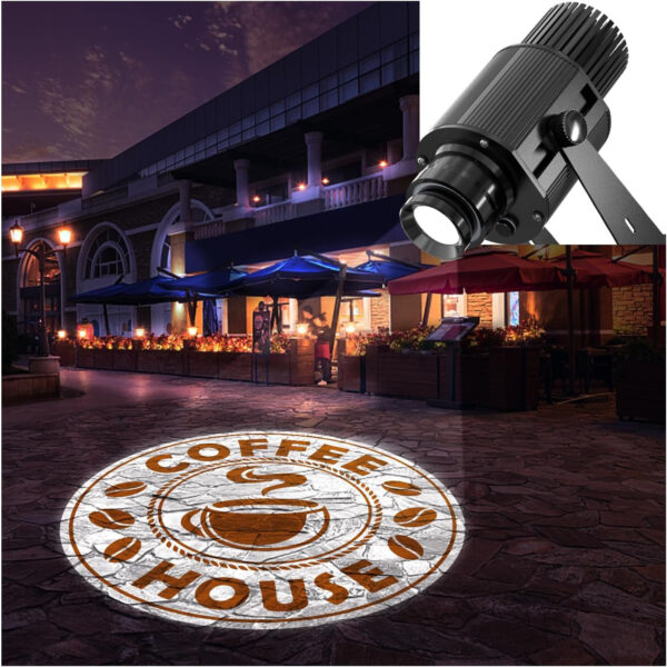 An outdoor nighttime scene features a coffee house with tables and umbrellas. On the ground, a circular logo projects a steaming coffee cup and the words Coffee House encircled by coffee beans using the Custom Logo Projection Made Easy - Gobo Projector, with a spotlight visible above.